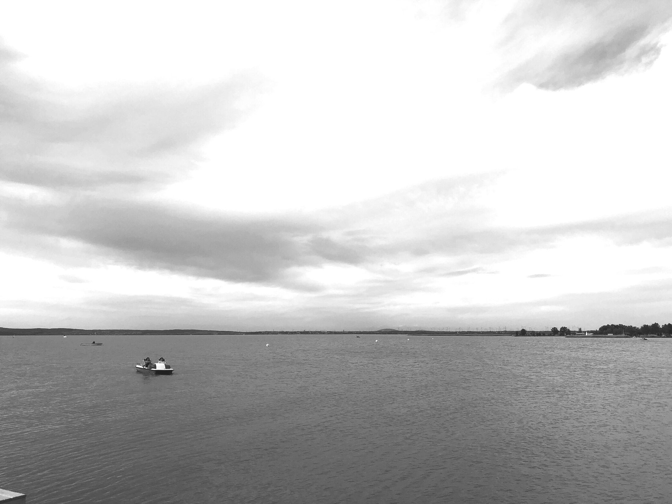Black-and-white lake under a dramatic sky