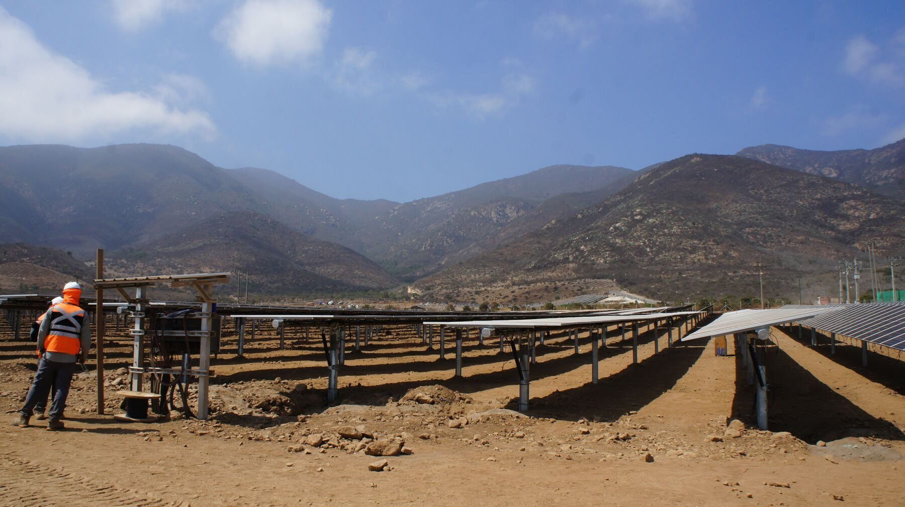 Workers installing posts during solar construction